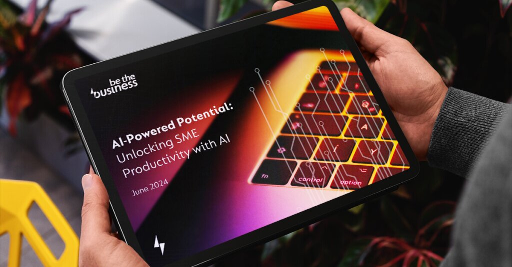 The cover of the AI-Powered Potential report shown on a tablet, being held between two hands.