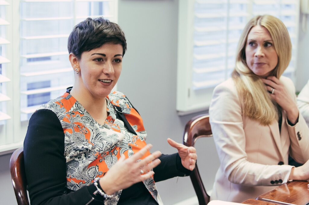 two women at a meeting table.